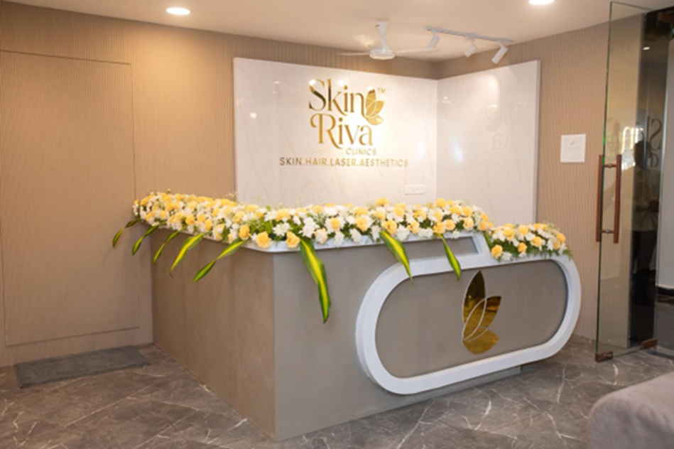 Reception counter with branded gold leaf logo and fresh floral arrangement